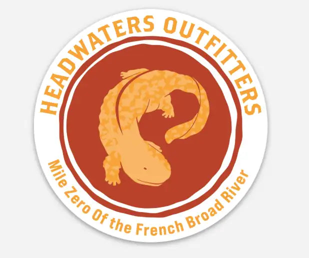Circular sticker featuring a stylized orange axolotl against a rust-colored background, with the text ’headwaters outfitters’ and ’mile zero of the french broad river’ in matching orange lettering.